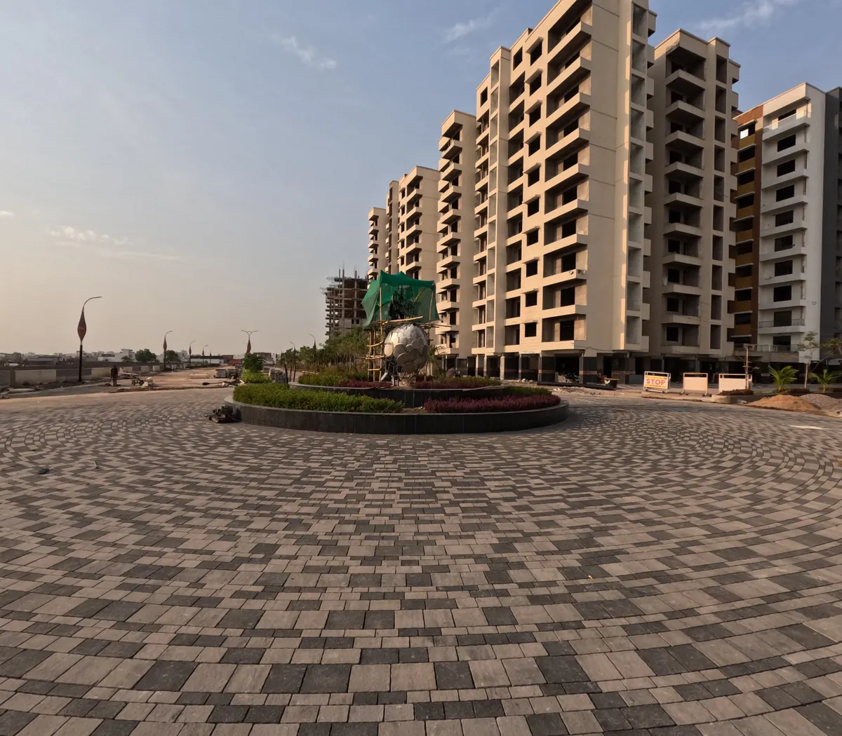 Circular paved entrance forecourt of a residential township with apartment towers behind