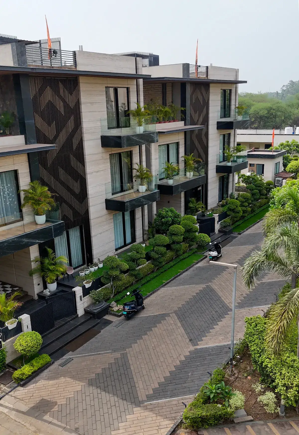 Residential villas with matching herringbone paver driveways across an entire development phase
